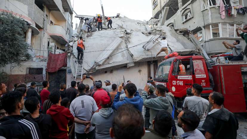 Palestinians inspect the site of an Israeli strike, in Gaza City