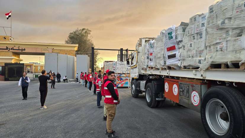 Trucks carrying aid bound for Gaza cross the border crossing between Egypt and the Gaza Strip
