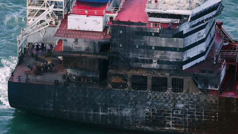 Aftermath of collision between container ship and oil tanker