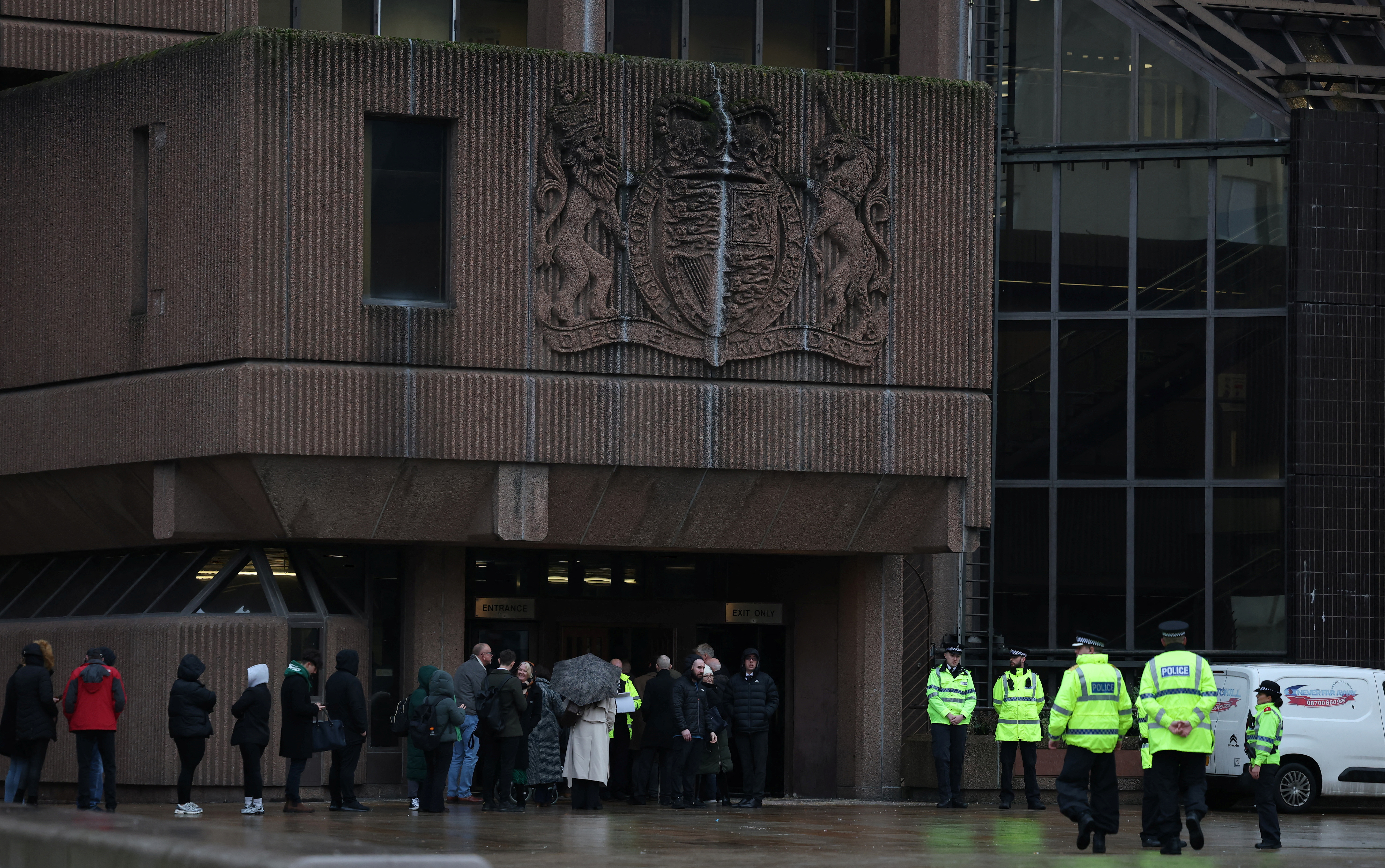 Police officers stand outside the front of Liverpool Crown Court at the start of the trial of Rudakubana