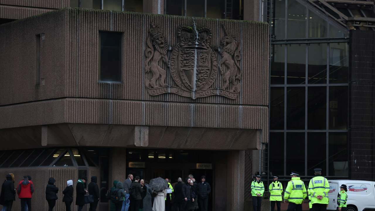 Police officers stand outside the front of Liverpool Crown Court at the start of the trial of Rudakubana