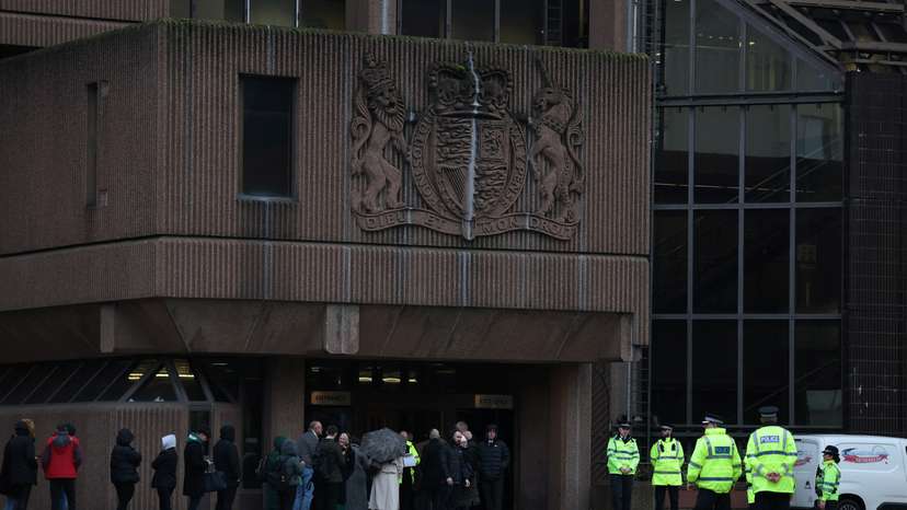 Police officers stand outside the front of Liverpool Crown Court at the start of the trial of Rudakubana