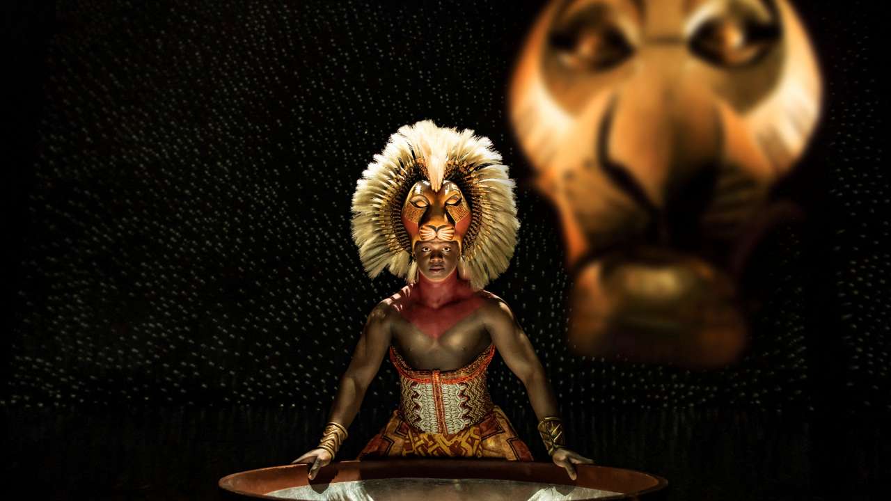 An actor wears a costume on stage during the performance of a musical "Lion King" in London
