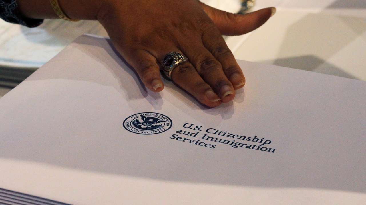 Information packs are distributed by the U.S. Citizenship and Immigration Services following a citizenship ceremony at the John F. Kennedy Presidential Library in Boston