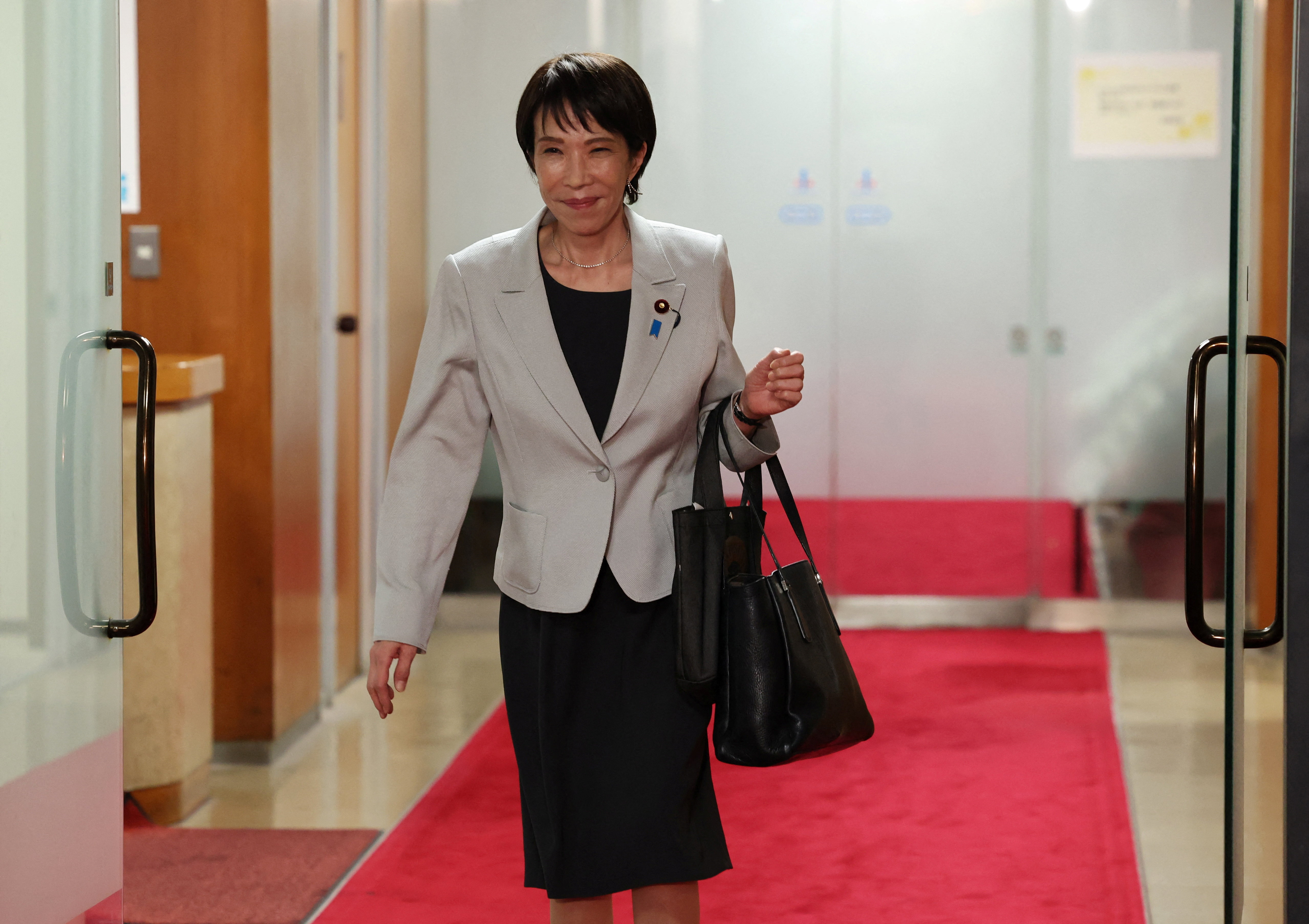 Leader of Japan's ruling LDP Sanae Takaichi leaves after a meeting with party members at its headquarters in Tokyo