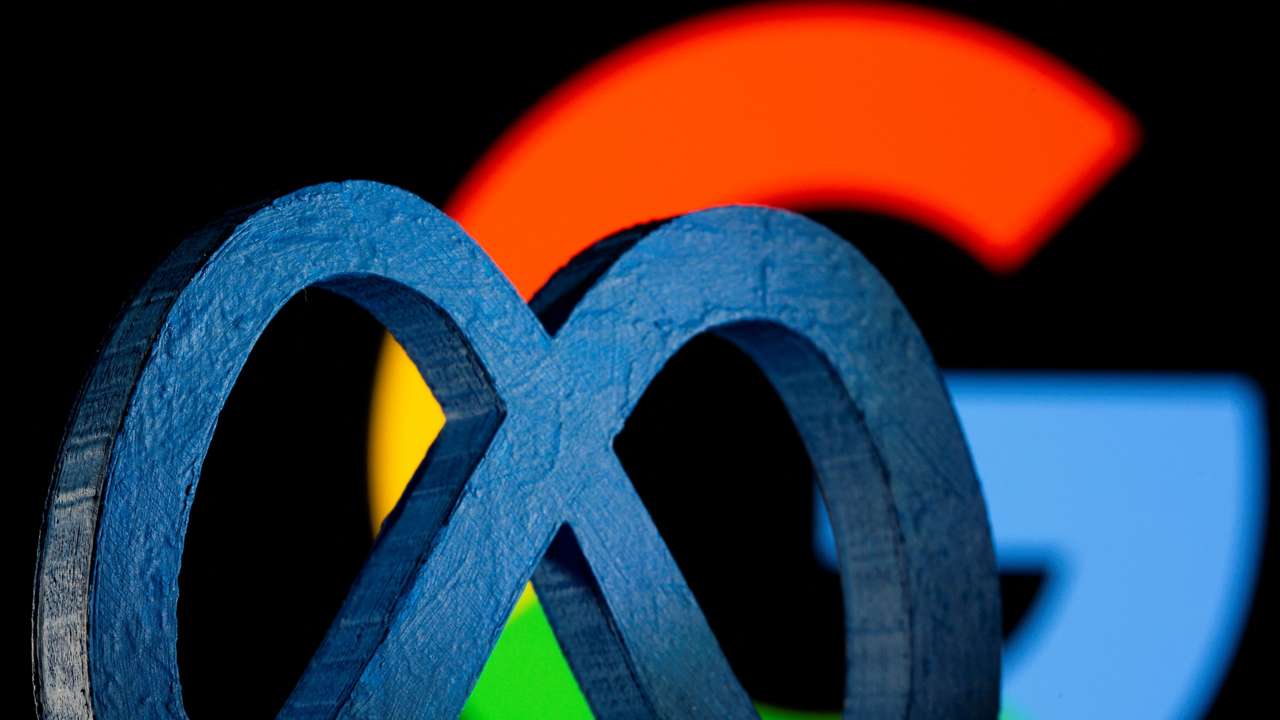 FILE PHOTO: A 3D printed Facebook's new rebrand logo Meta is seen in front of displayed Google logo in this illustration