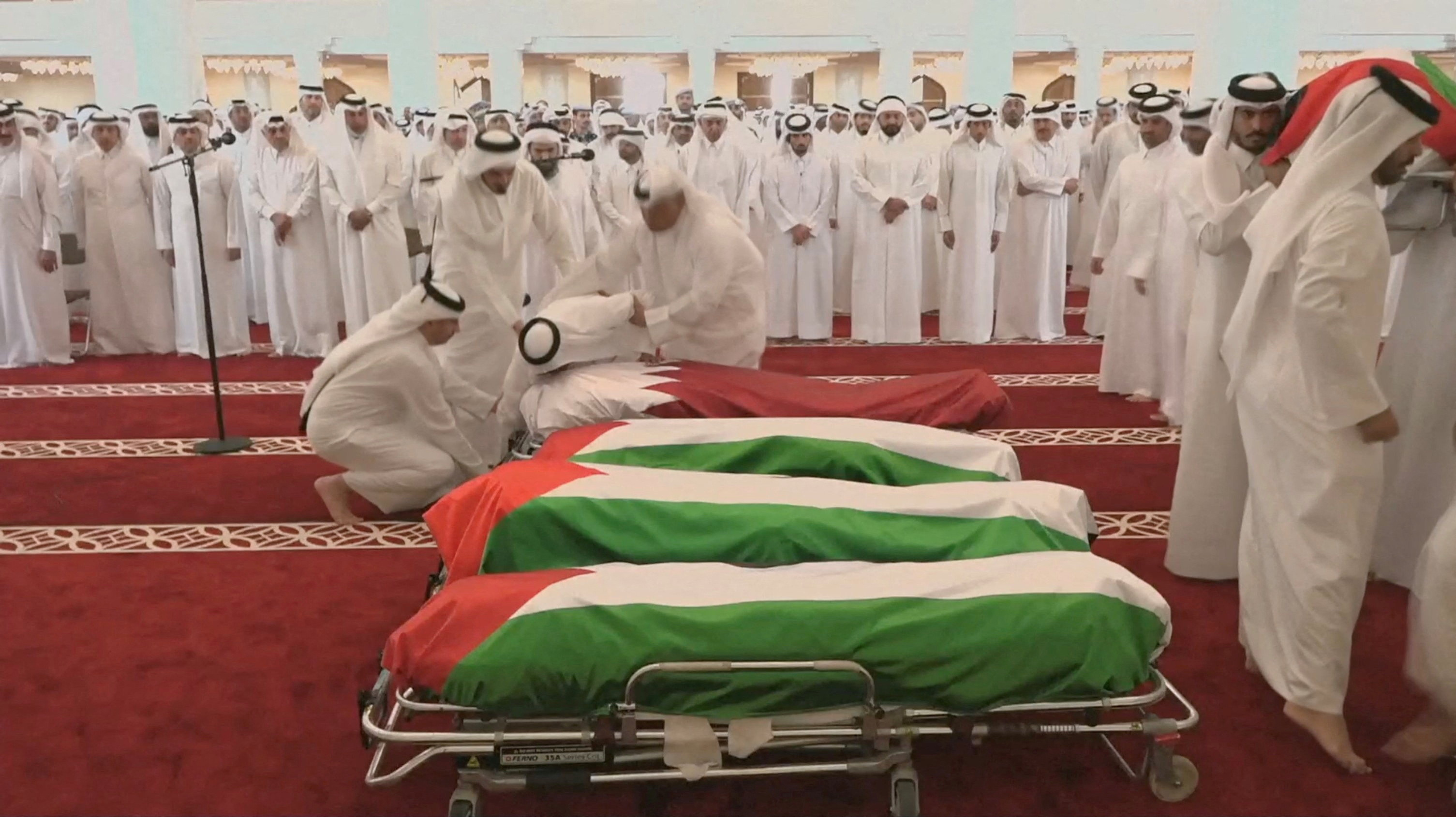 FILE PHOTO: People attend a funeral held for those killed by an Israeli attack in Doha
