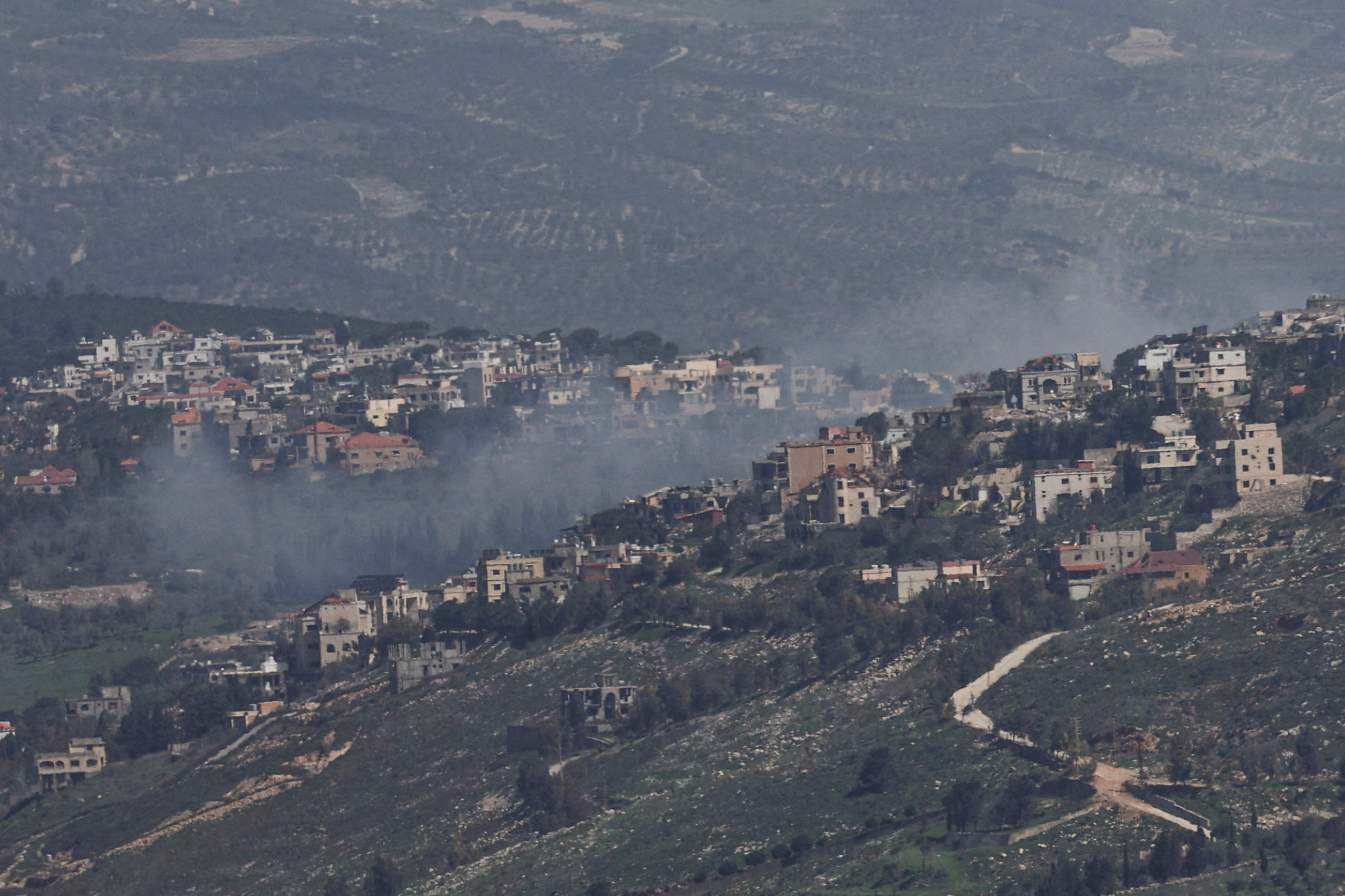 FILE PHOTO: Smoke rises from a Lebanese village near the border with Israel, amid escalation between Iran-backed Hezbollah and Israel, and amid the U.S.-Israeli conflict with Iran, as seen from northern Israel