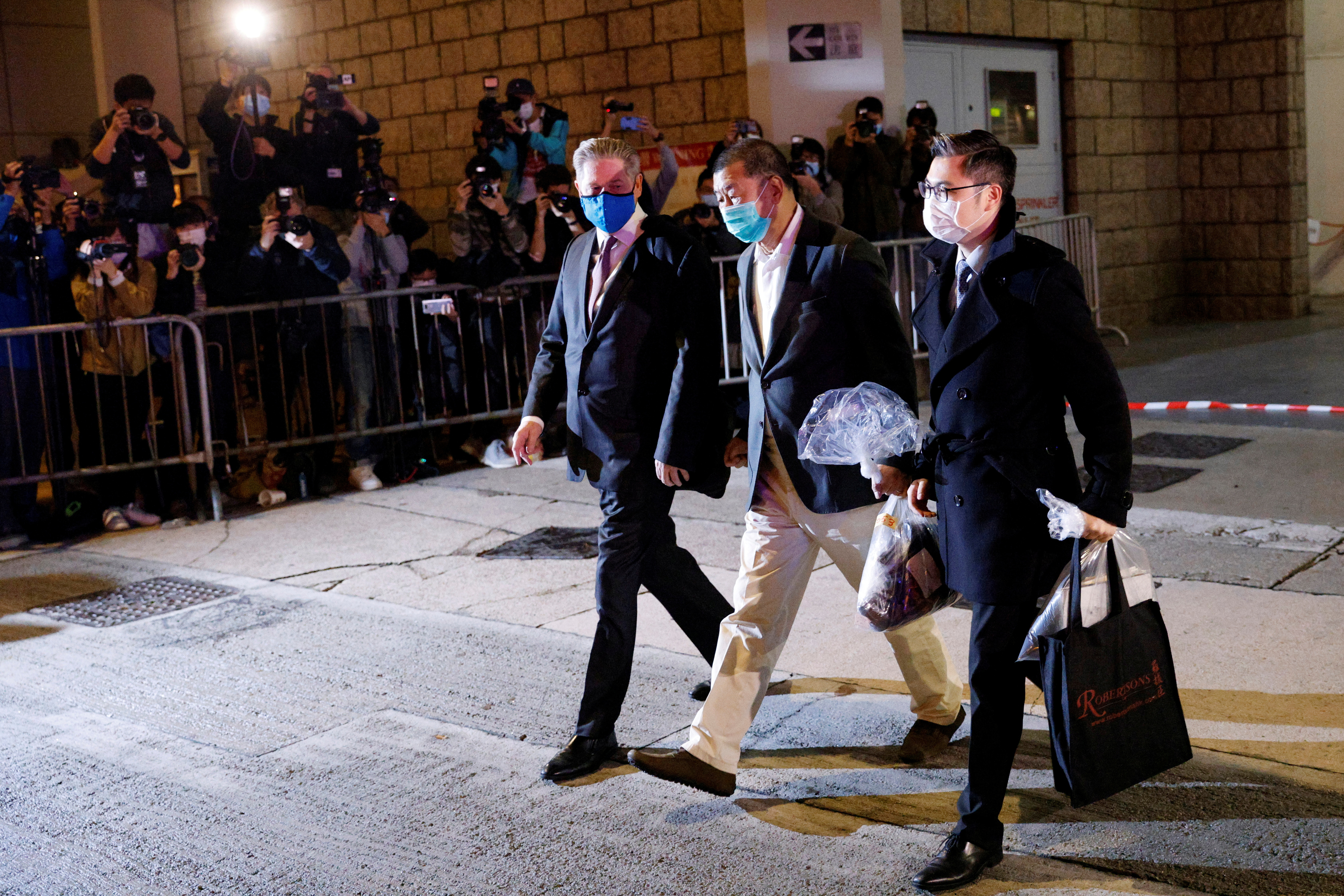 Media mogul Jimmy Lai Chee-ying, founder of Apple Daily, leaves the High Court on bail, in Hong Kong