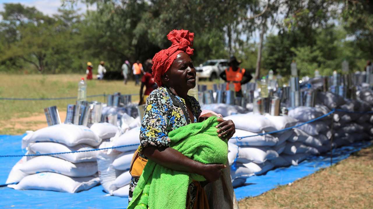 FILE PHOTO: Villagers collect monthly allocations of food aid provided by WFP in Mumijo