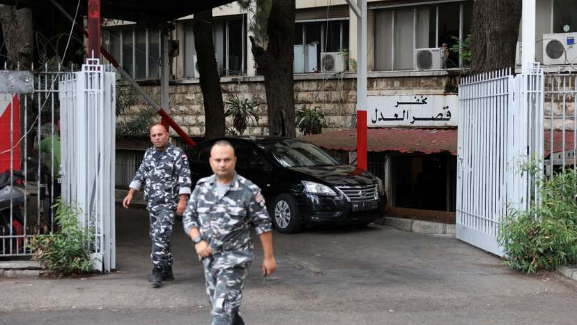 Lebanese police officers walk outside the Justice Palace in Beirut