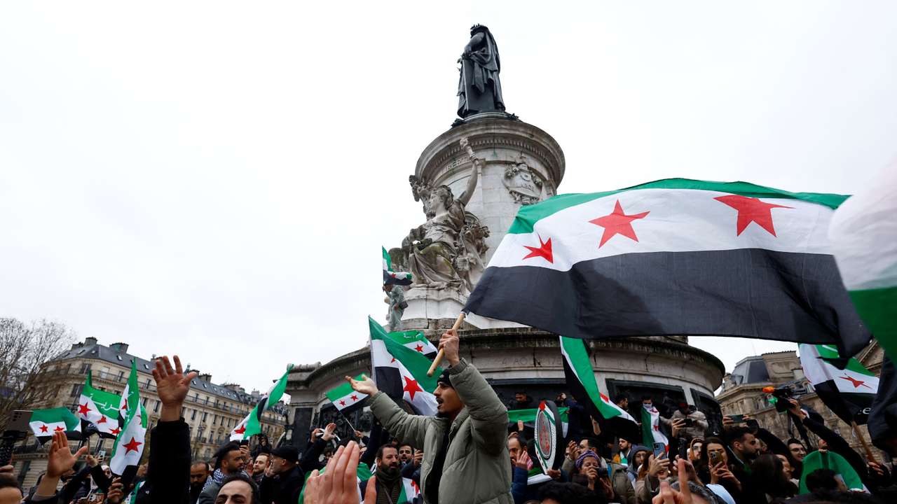 People gather in Paris, after Syrian rebels announced that they have ousted President Bashar al-Assad