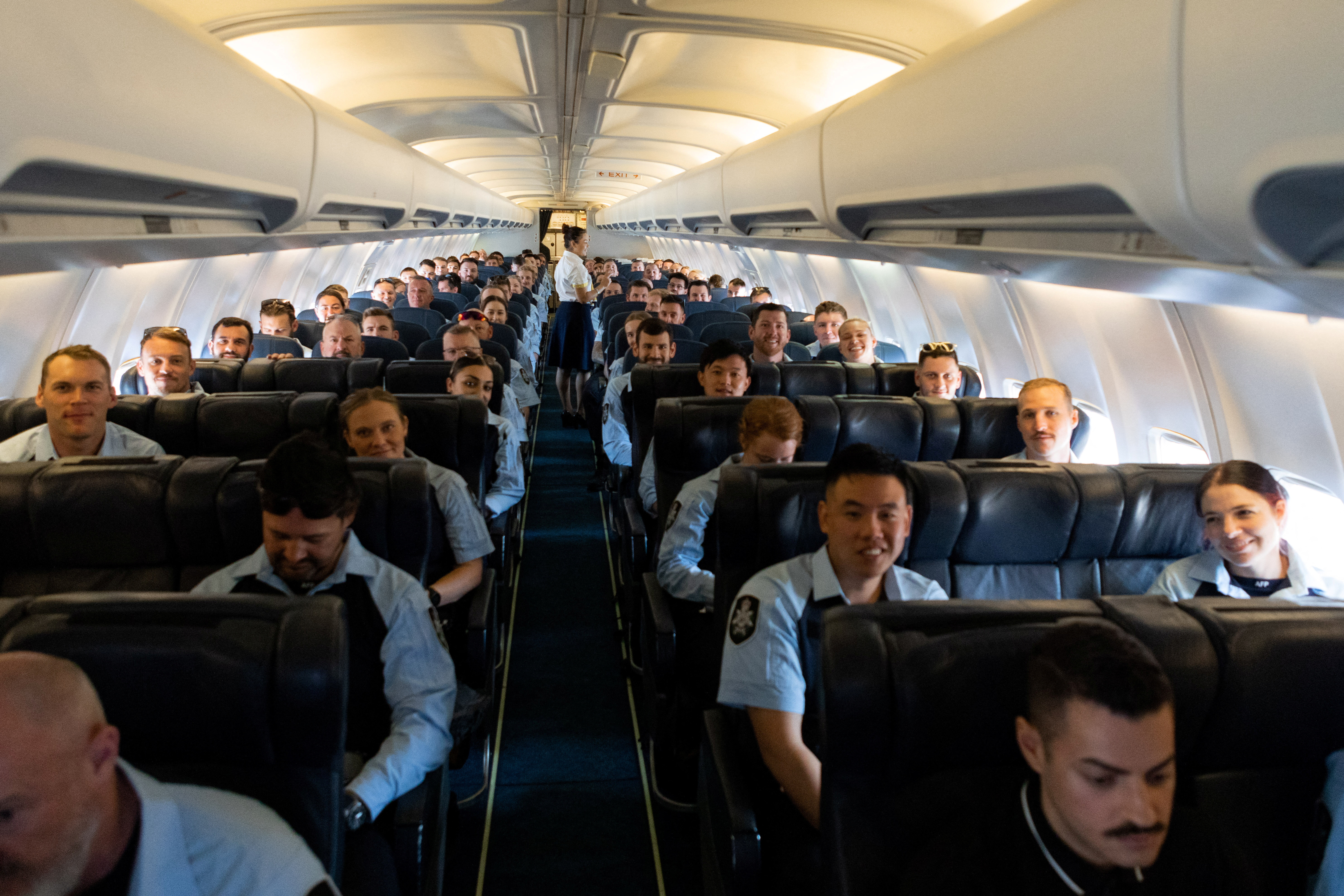 Members of the Australian Federal Police board a flight to the Solomon Islands in Australia
