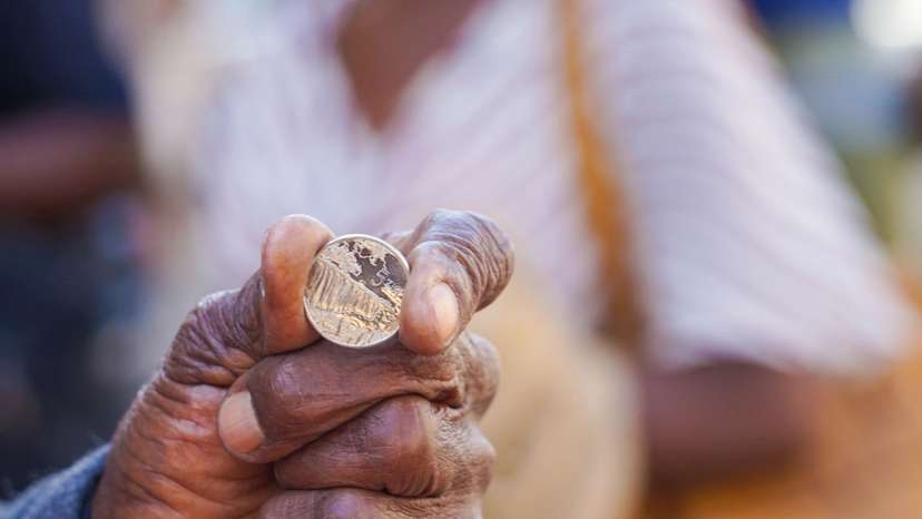 A man holds a ZiG coin, part of Zimbabwe's sixth currency since independence in 1980.