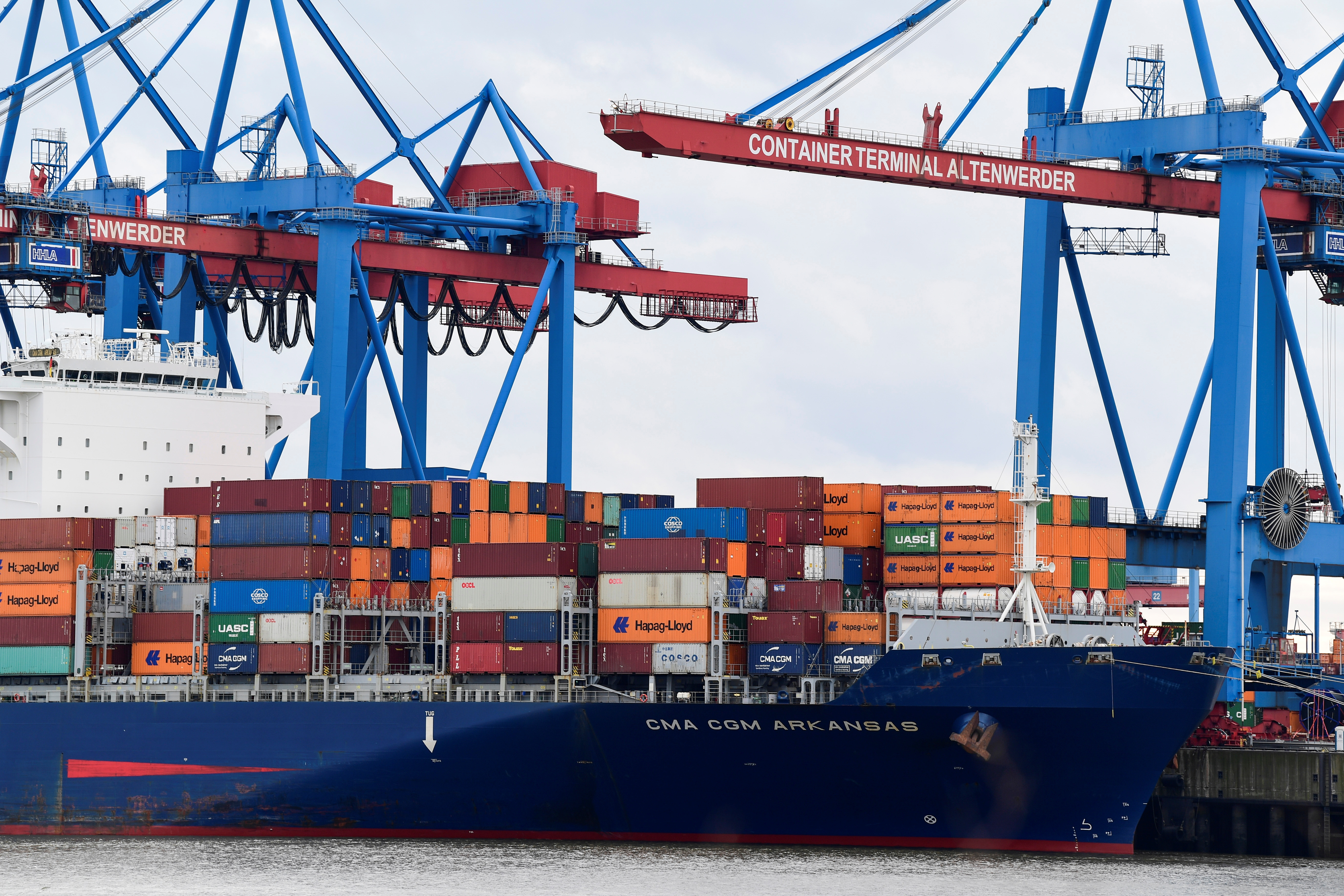 Containers are loaded on a container ship at a terminal at the harbour in Hamburg