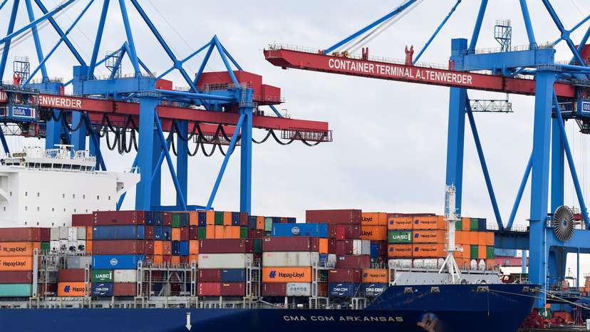 Containers are loaded on a container ship at a terminal at the harbour in Hamburg
