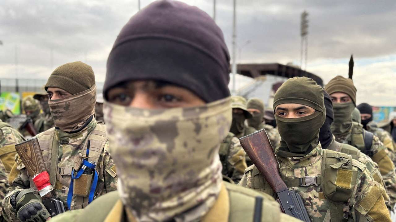 FILE PHOTO: Khaled Brigade, a part of Hay'at Tahrir al-Sham (HTS), hold a military parade, in Damascus