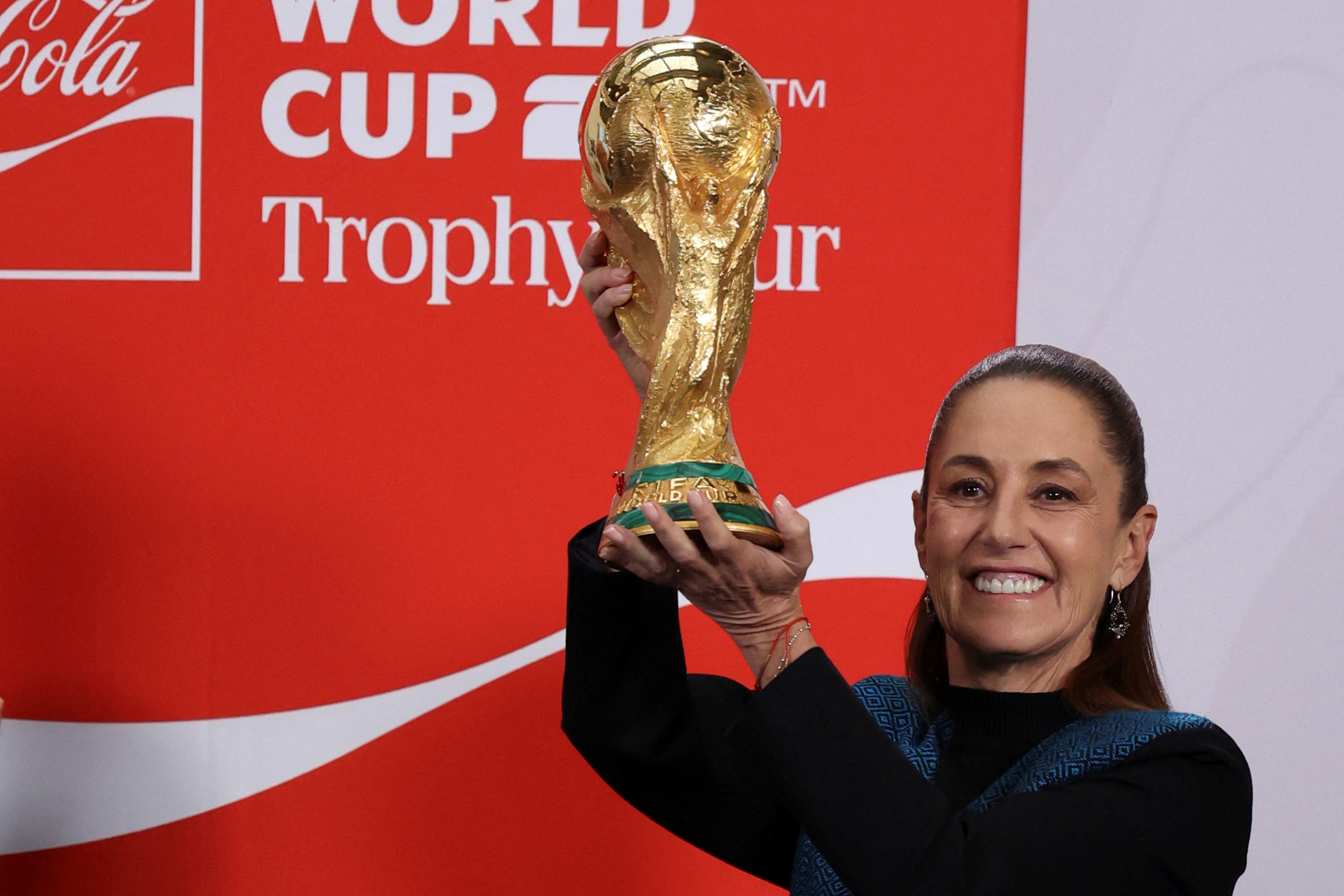 Mexican President Claudia Sheinbaum holds FIFA World Cup trophy at National Palace