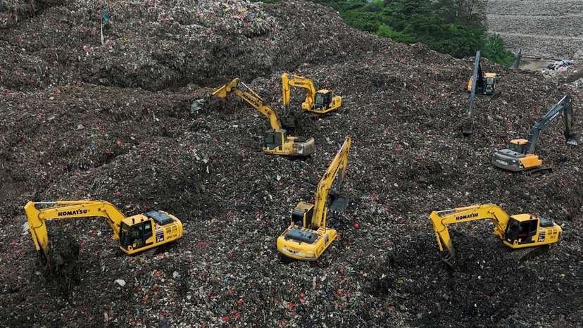 A drone view shows excavators operating amid garbage at the site of collapse at the Bantar Gebang landfill during a rescue operation in Bekasi