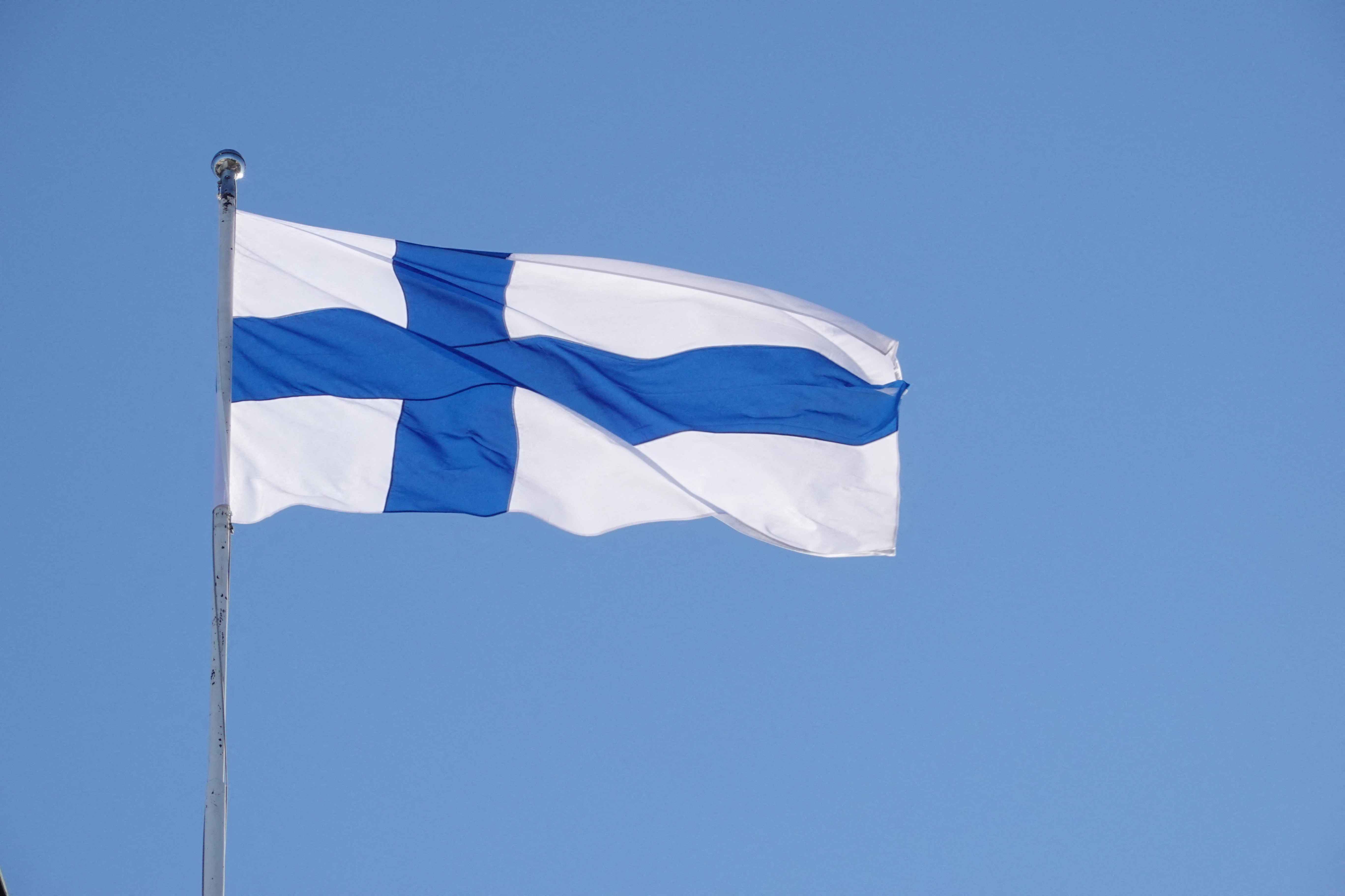 FILE PHOTO: The Finnish flag flutters outside the city hall, as Finland becomes a member of NATO, in Helsinki