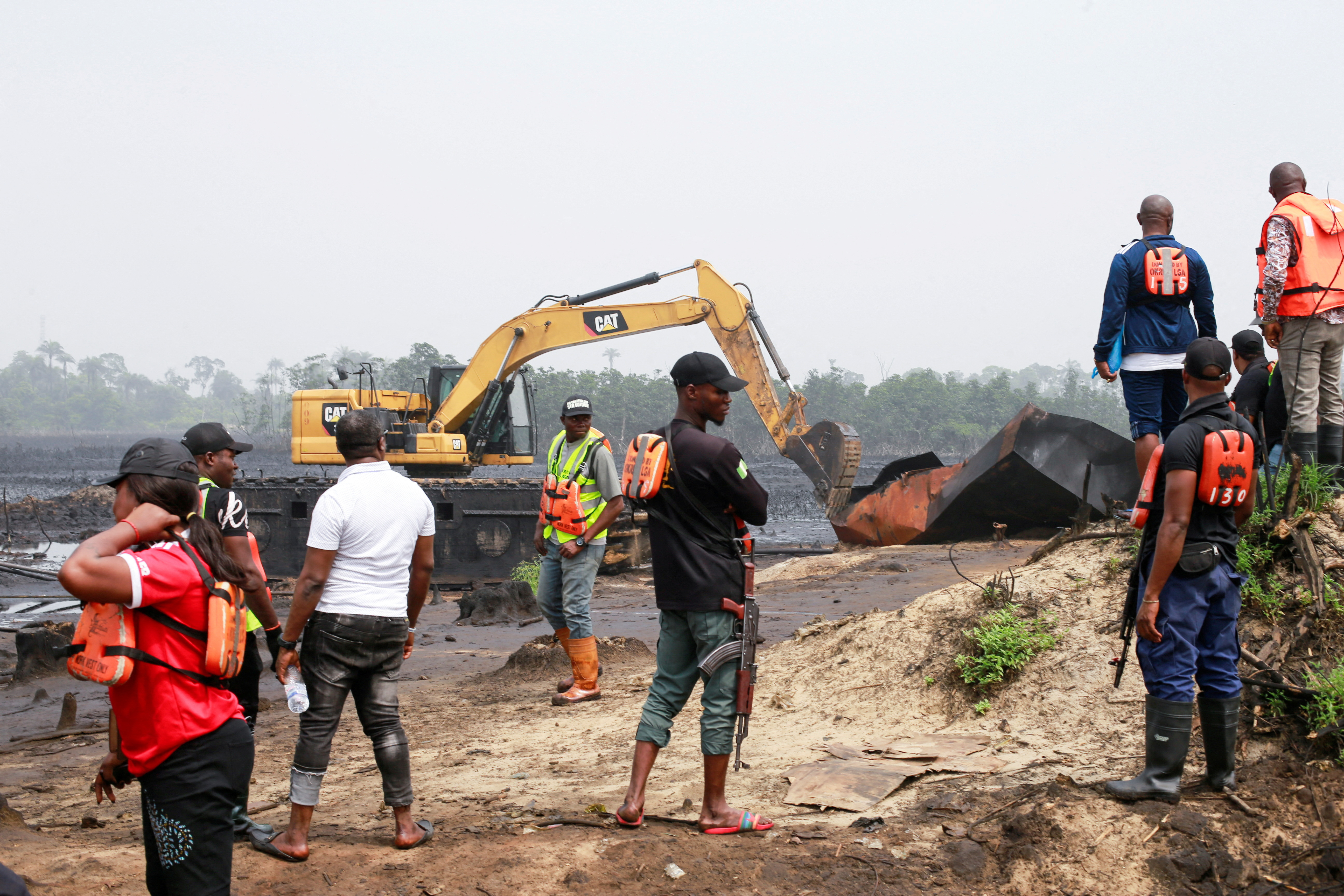 FILE PHOTO: Machinery is used to destroy several implements used by the illegal artisanal crude oil workers in the Niger delta area of Bakana ii illegal camp in Okrika