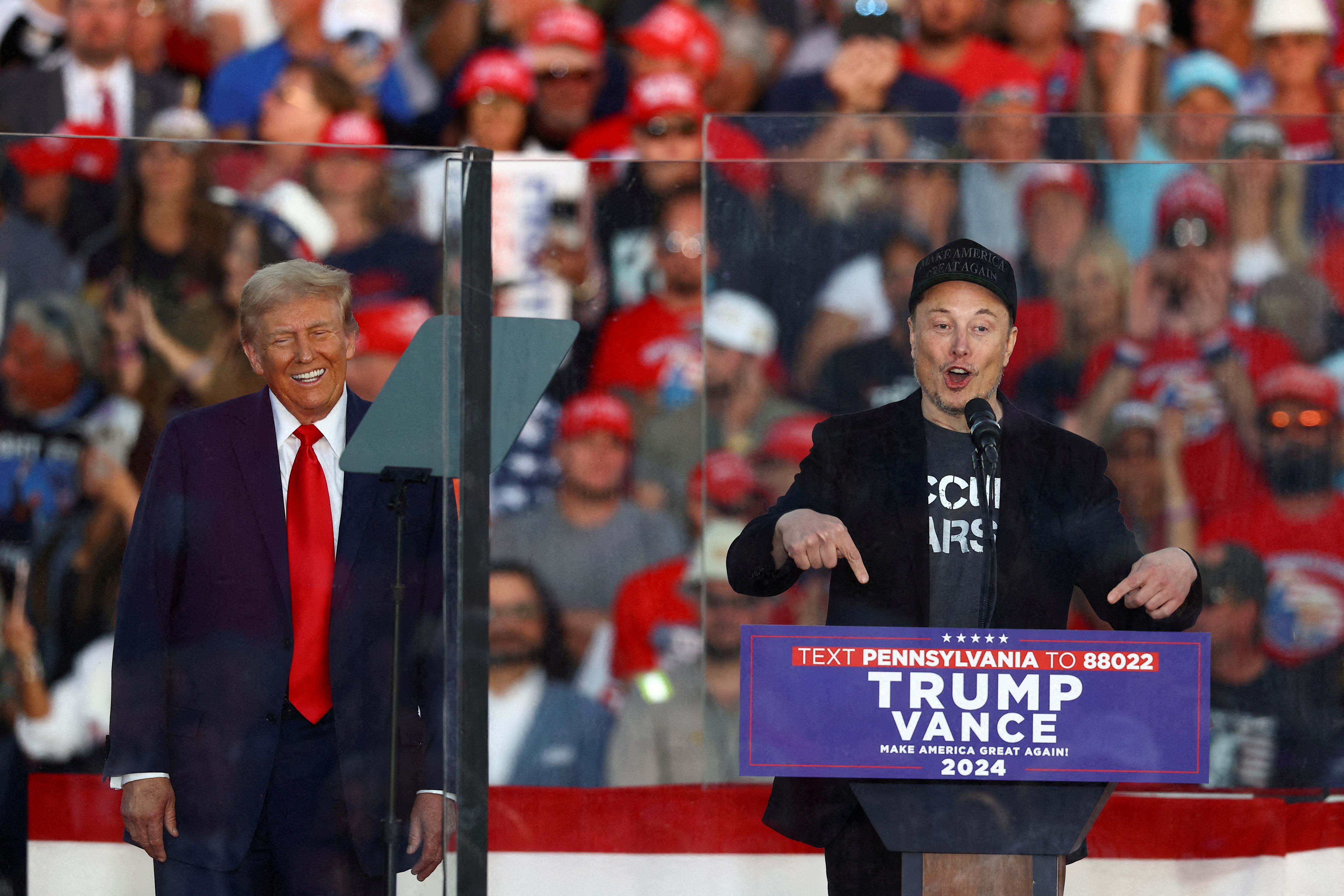 FILE PHOTO: FILE PHOTO: Tesla CEO and X owner Elon Musk speaks as Donald Trump reacts during a rally in Butler