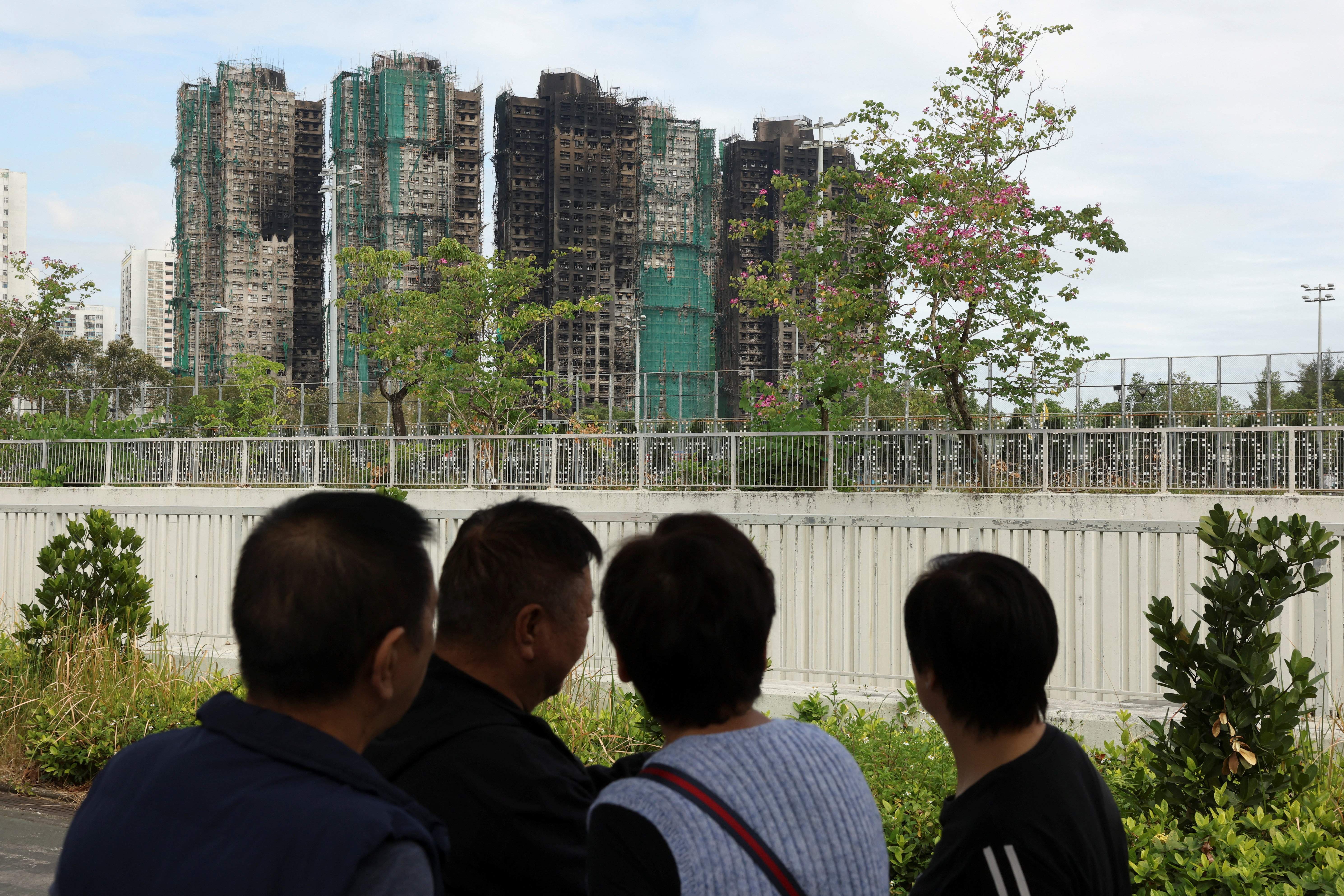 People stand near the Wang Fuk Court housing complex in Hong Kong