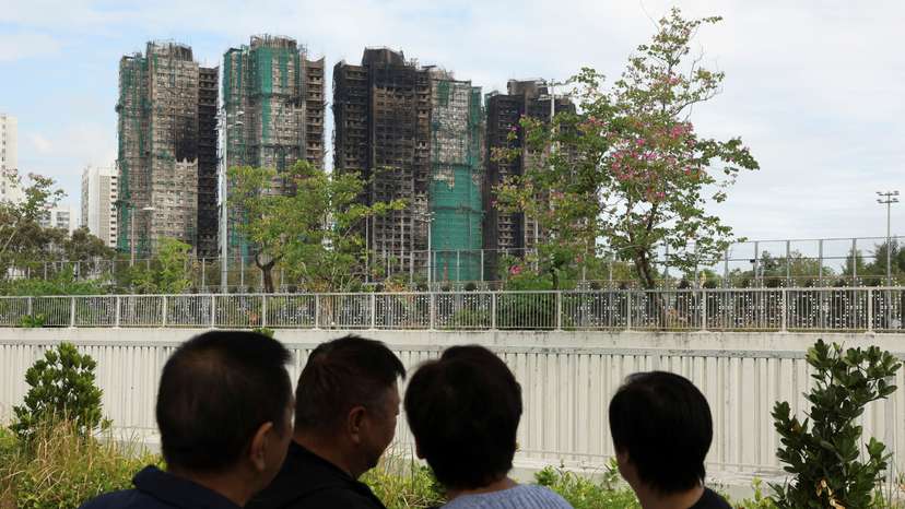 People stand near the Wang Fuk Court housing complex in Hong Kong
