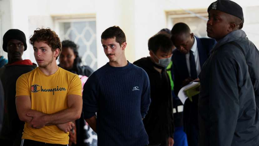 Belgium nationals David Lornoy and Seppe Lodewijckx look on, after they appeared in court, in Nairobi