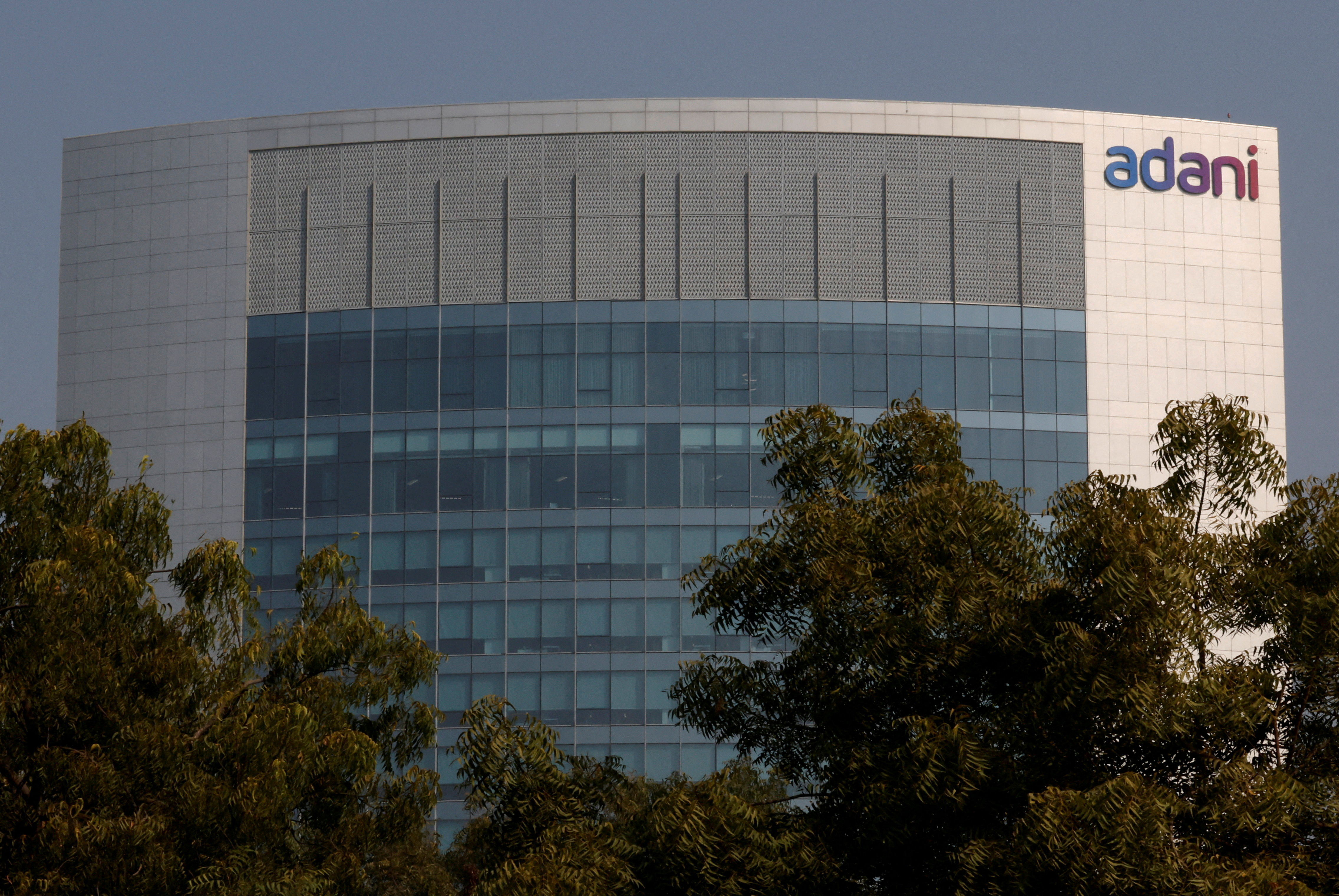 FILE PHOTO: The logo of the Adani Group is seen on the facade of its Corporate House on the outskirts of Ahmedabad