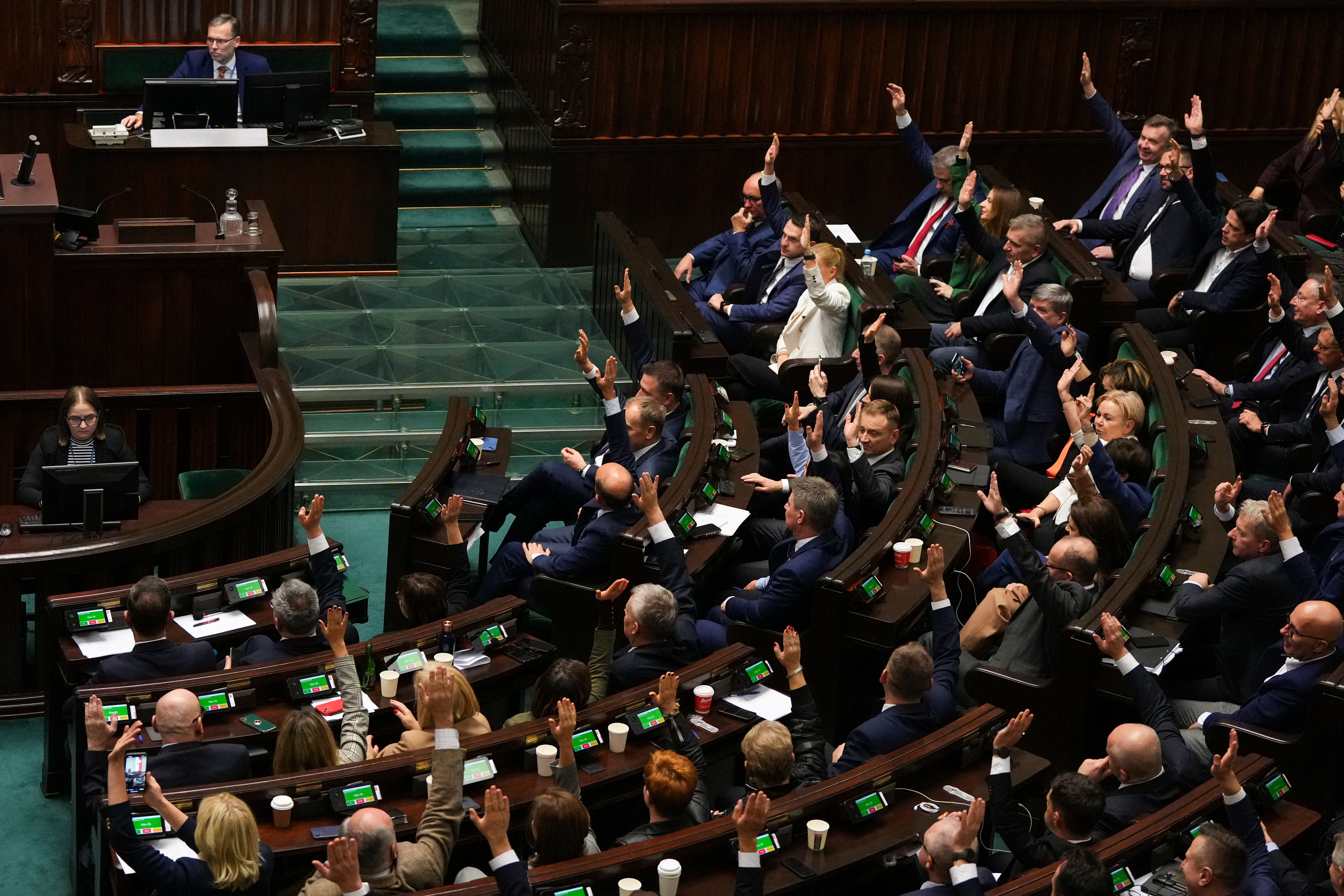 Members of the Polish Parliament vote in favor of newly appointed Polish Prime Minister Donald Tusk's government, in Parliament, in Warsaw