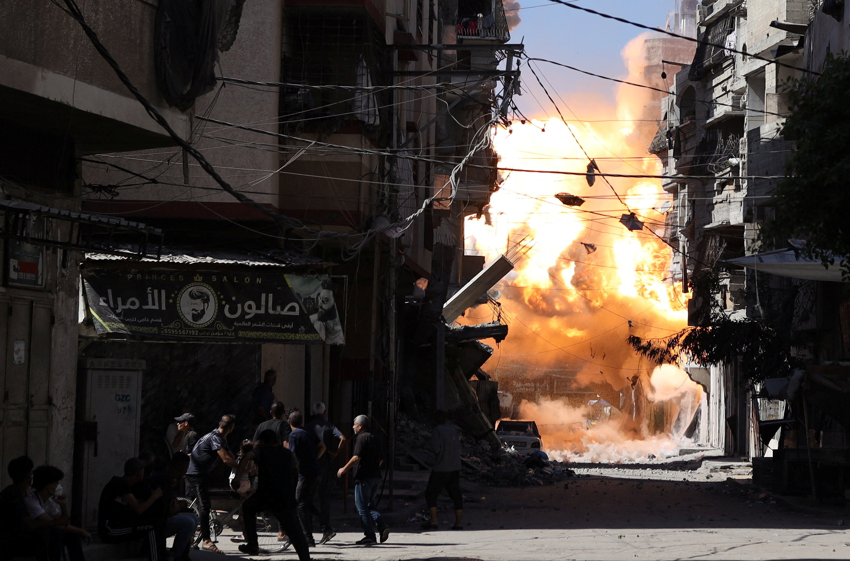 Smoke and flames rise as an Israeli airstrike hits a house, in Gaza City
