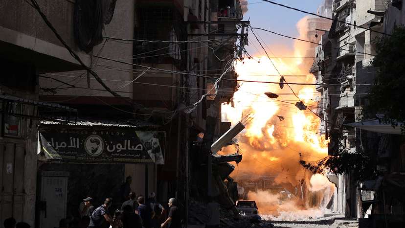 Smoke and flames rise as an Israeli airstrike hits a house, in Gaza City