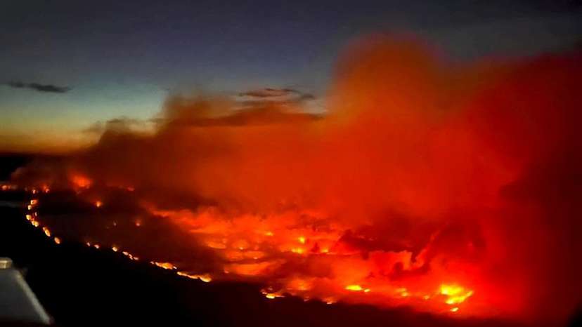 FILE PHOTO: The Parker Lake wildfire glows in an aerial photograph taken by a B.C. Emergency Health Services crew member