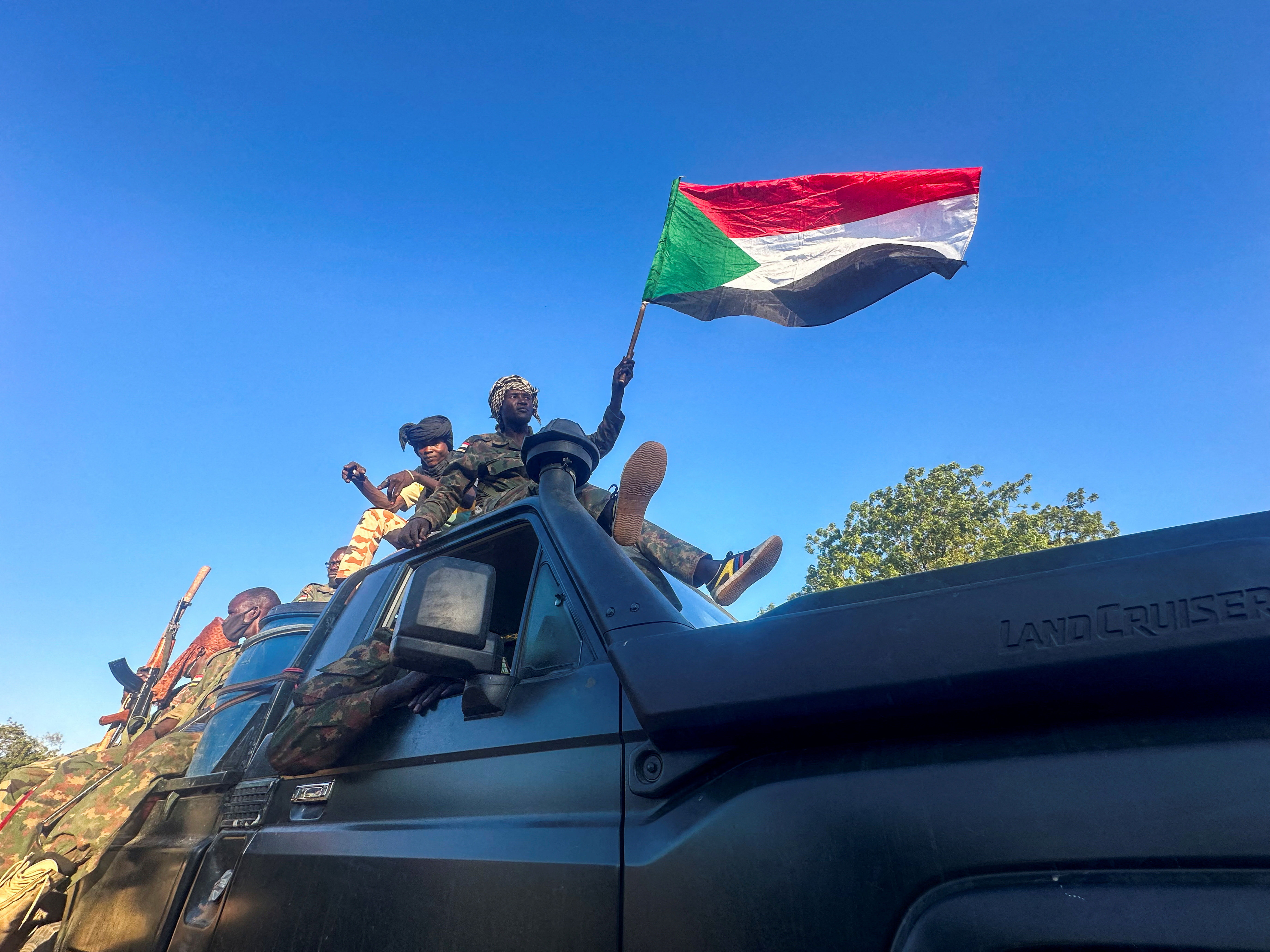 Sudan's army soldiers celebrate after entering Wad Madani