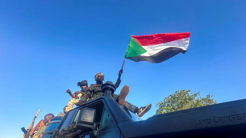 Sudan's army soldiers celebrate after entering Wad Madani