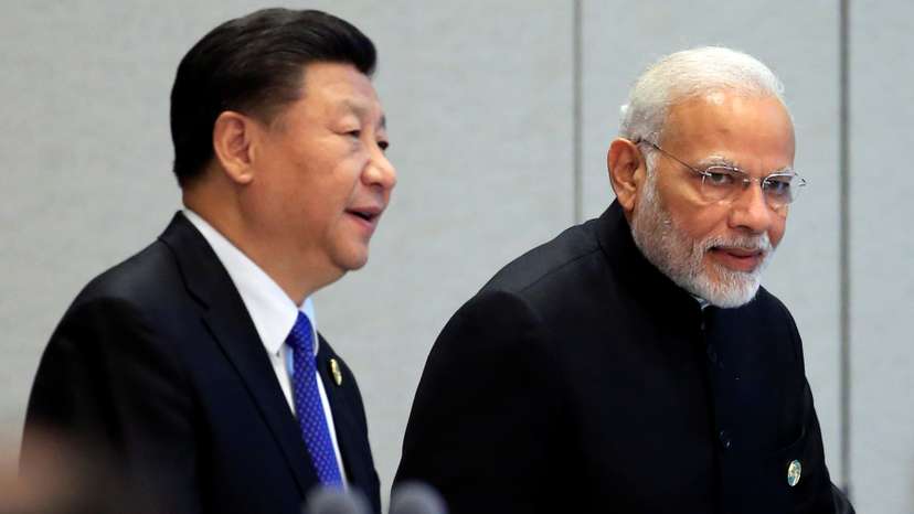 China's President Xi Jinping and India's Prime Minister Narendra Modi arrive for a signing ceremony during Shanghai Cooperation Organization (SCO) summit in Qingdao