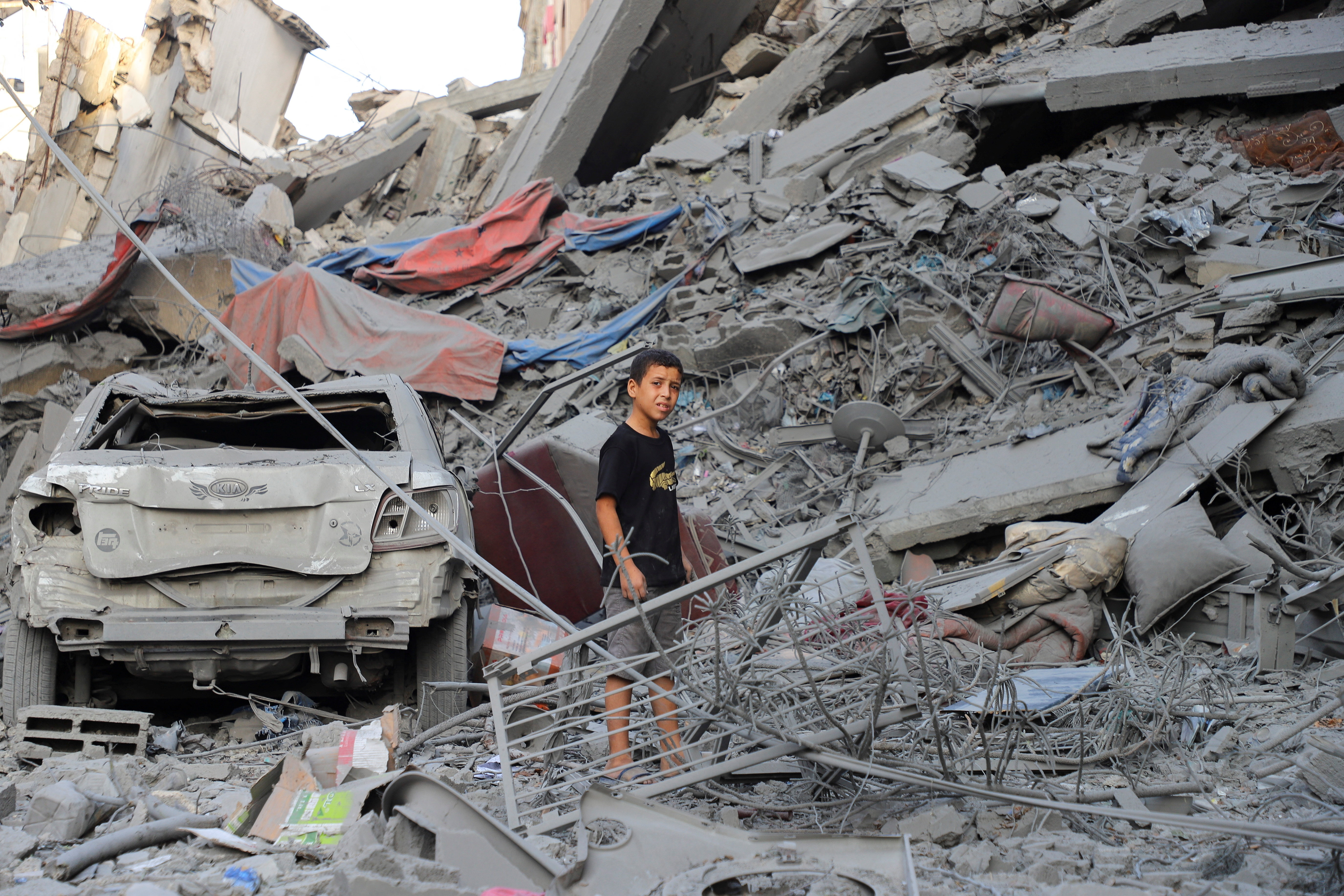 Palestinians inspect the site of Israeli strikes on houses at Shati (Beach) refugee camp in Gaza City