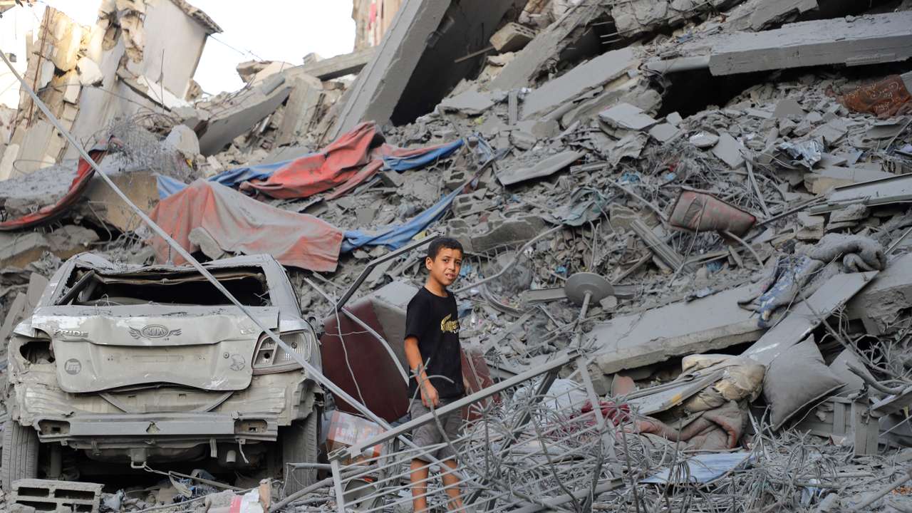 Palestinians inspect the site of Israeli strikes on houses at Shati (Beach) refugee camp in Gaza City