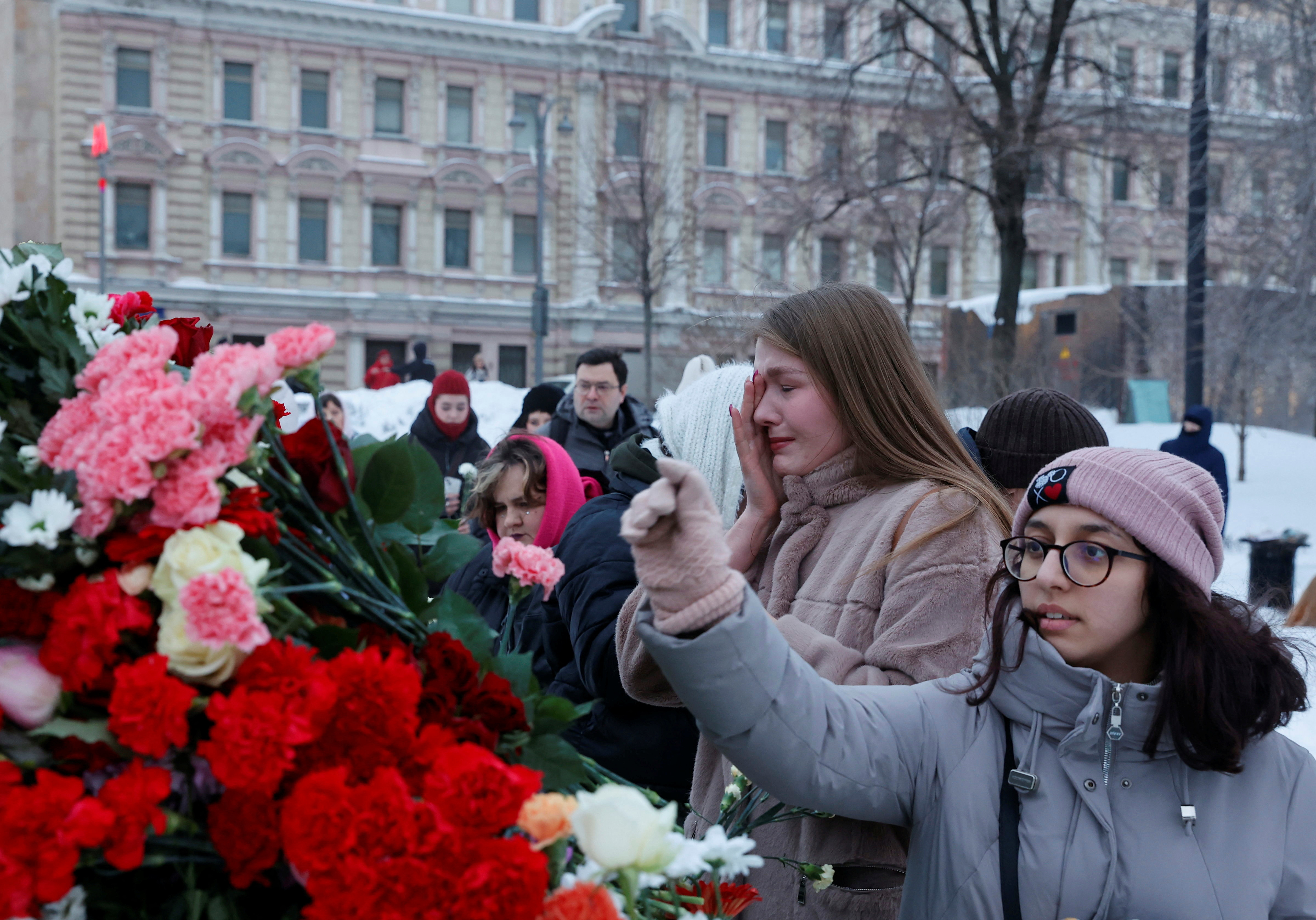 People lay flowers in memory of Alexei Navalny in Moscow