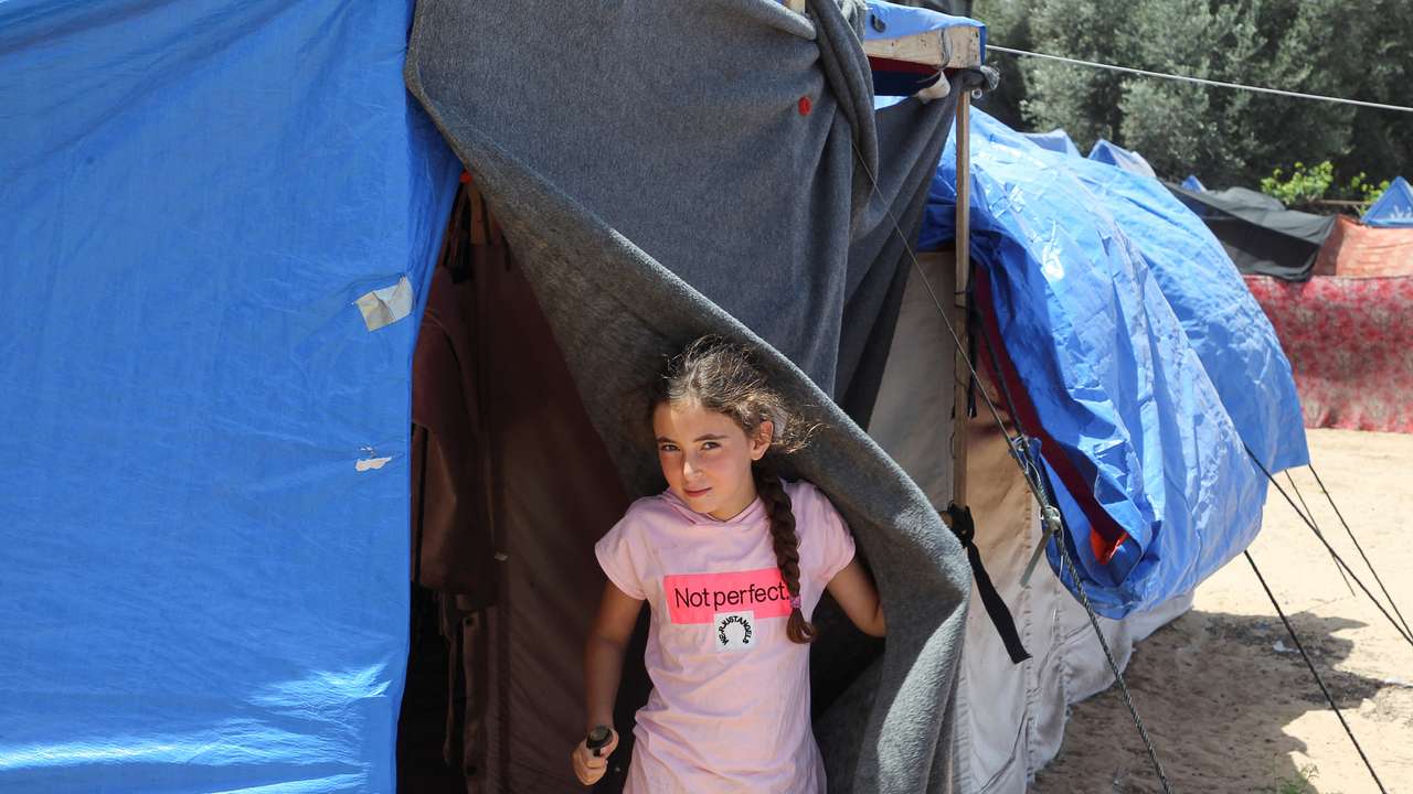 Displaced Palestinians, who fled their houses due to Israeli strikes, shelter at a tent camp in Rafah