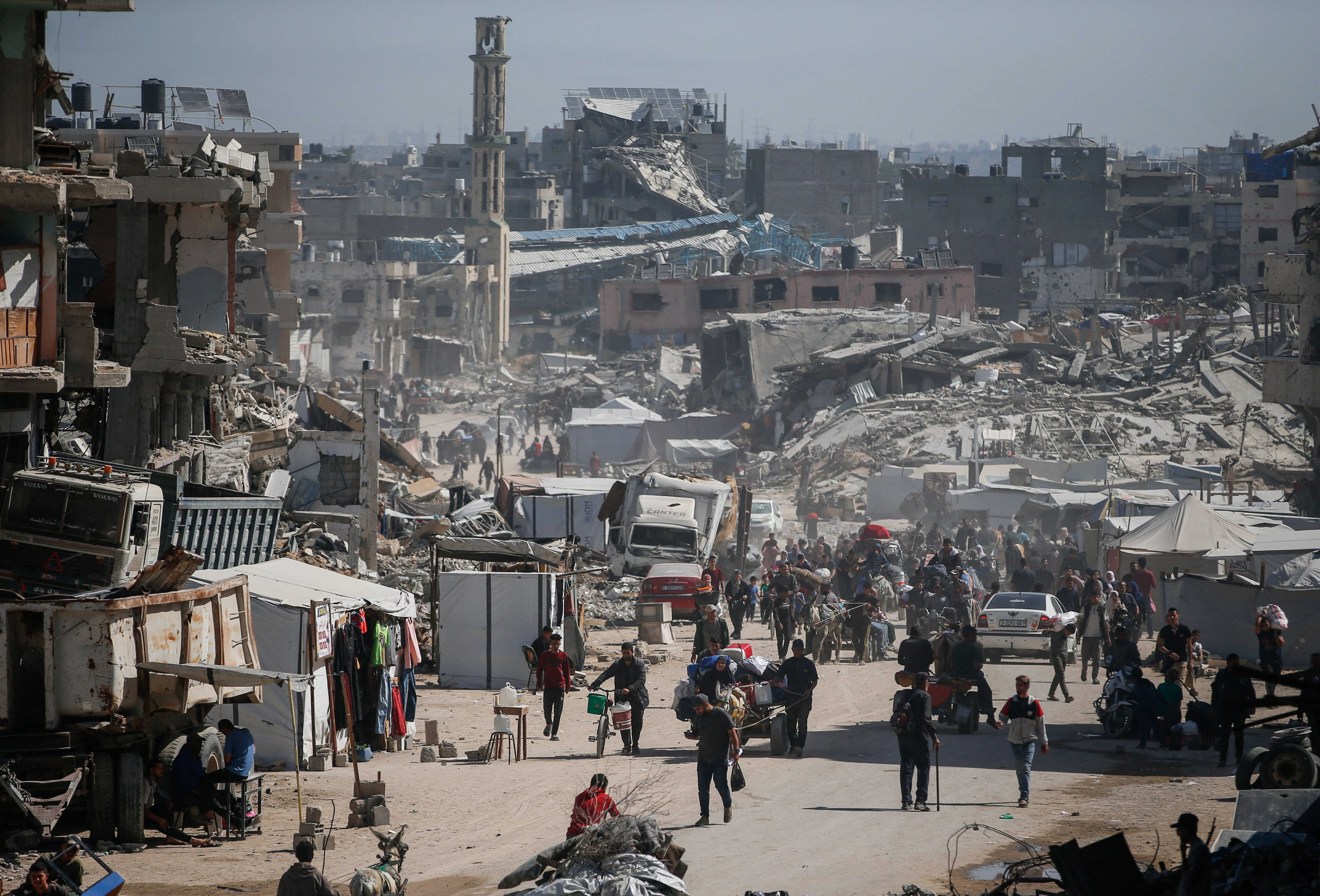 Palestinians make their way with belongings as they fled their homes