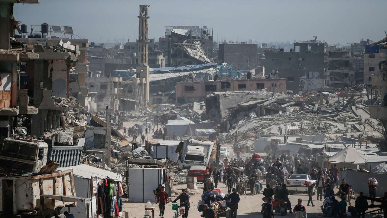 Palestinians make their way with belongings as they fled their homes