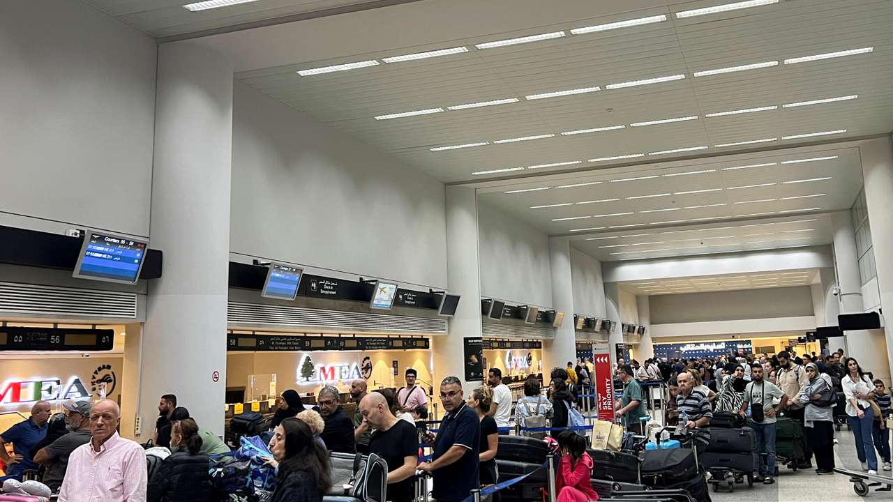 Passengers queue at the check-in counters at Beirut-Rafic Al Hariri International Airport