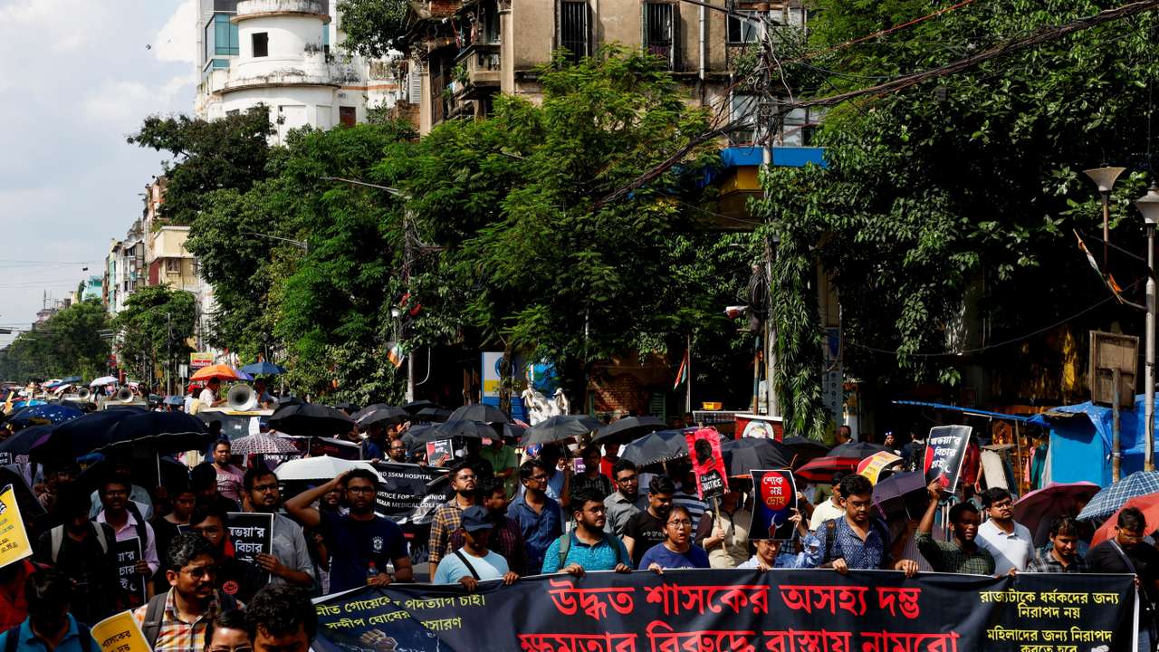 Medics march along a street during a protest condemning the rape and murder of a trainee medic at a government-run hospital, in Kolkata