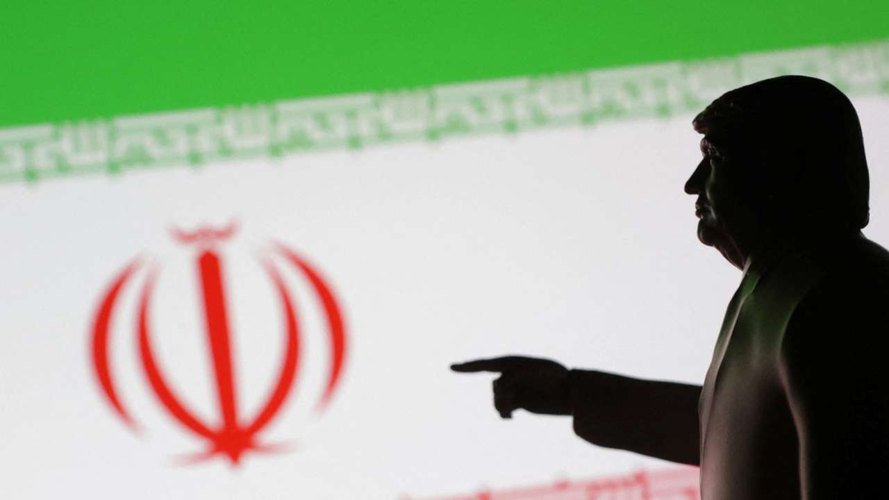 Illustration shows 3D-printed miniature model depicting U.S. President Donald Trump and Iran flag