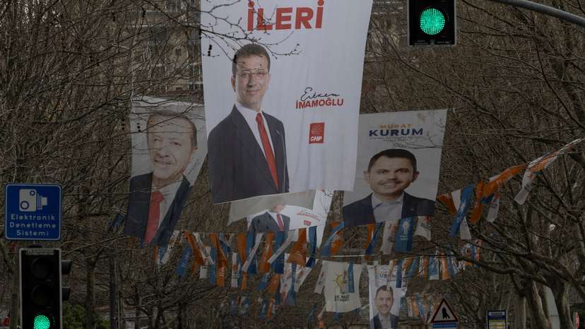 Election banners of Istanbul's mayor Ekrem Imamoglu, President Tayyip Erdogan and Murat Kurum hang along a street ahead of the local elections in Istanbul