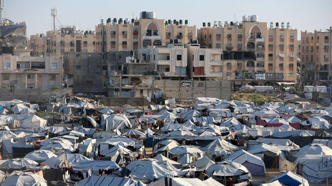 Palestinians displaced during the two-year Israeli offensive shelter at a tent camp in Khan Younis