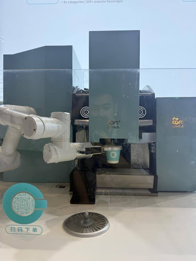 A robot is making coffee based on a photo