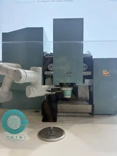 A robot is making coffee based on a photo